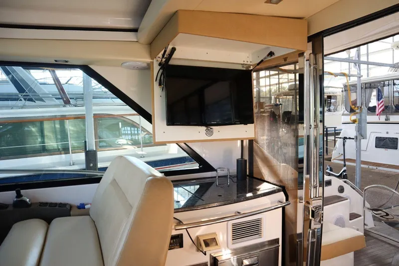 Slide: The Image of Interior of 2010 Regal 46 Sport Coupe yacht with TV and seating area. - 31