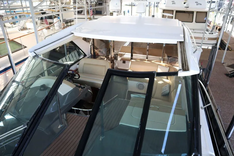 Slide: The Image of 2010 Regal 46 Sport Coupe yacht interior with helm and seating area. - 32