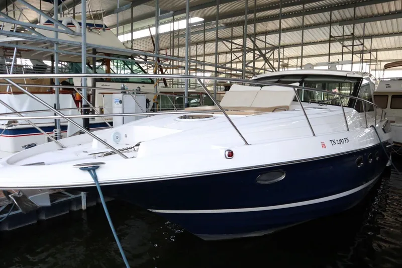 Slide: The Image of 2010 Regal 46 Sport Coupe yacht docked in a marina, showcasing sleek design and luxury features. - 8