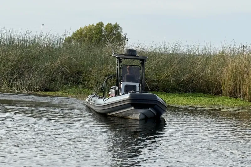 Slide: The Image of 2023 Inmar 660R-PT-PR boat navigating through marshy waters. - 16