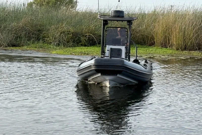 Slide: The Image of 2023 Inmar 660R-PT-PR boat navigating through marshy waters. - 17