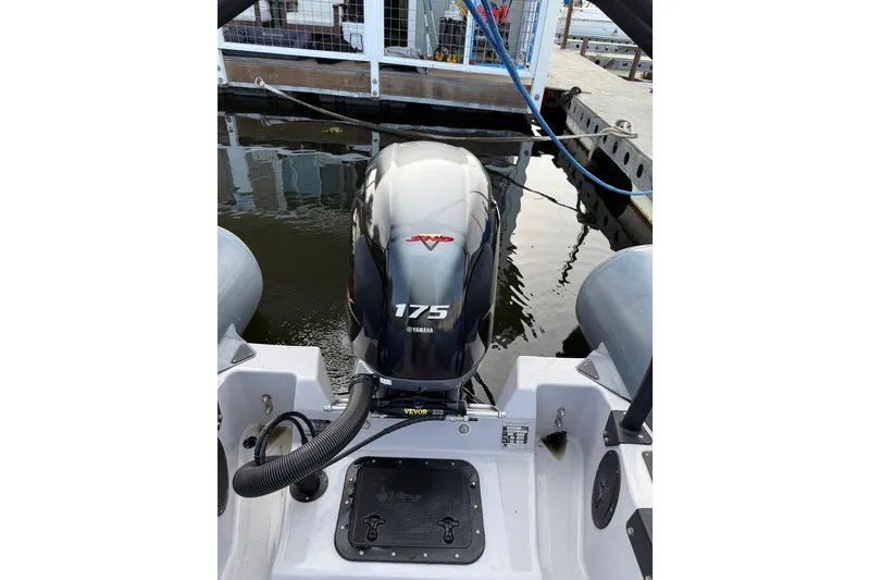 Slide: The Image of 2023 Inmar 660R-PT-PR boat with Yamaha 175 outboard motor at dock. - 2