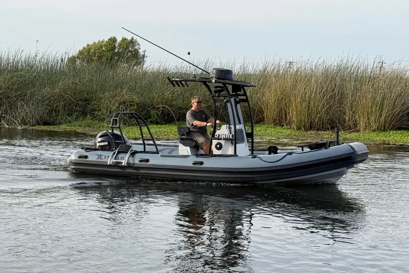 Slide: The Image of 2023 Inmar 660R-PT-PR boat navigating through calm waters near reeds. - 20