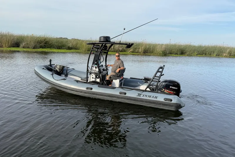Slide: The Image of 2023 Inmar 660R-PT-PR boat on calm water with a person steering. - 25