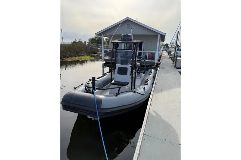Slide: The Image of 2023 Inmar 660R-PT-PR boat docked at a marina, featuring sleek design and modern equipment. - 6