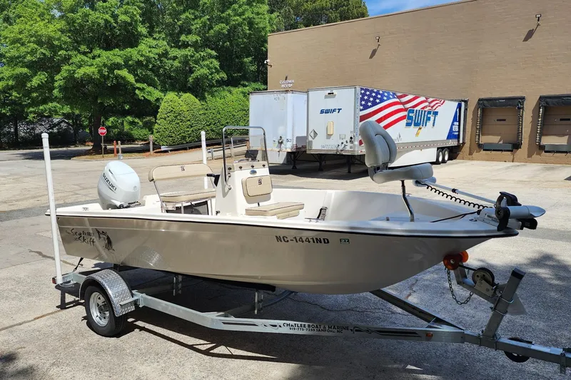 Slide: The Image of 2024 Carolina Skiff EV180 Sea Skiff on trailer in parking lot. - 3