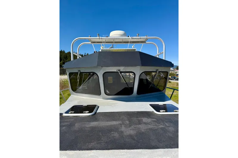 Slide: The Image of 2001 Maxweld Maxcat boat with sleek cabin design under clear blue sky. - 14