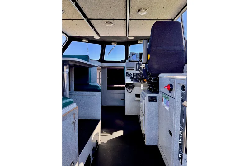 Slide: The Image of Interior of a 2001 Maxweld Maxcat boat, featuring control panel and seating. - 17