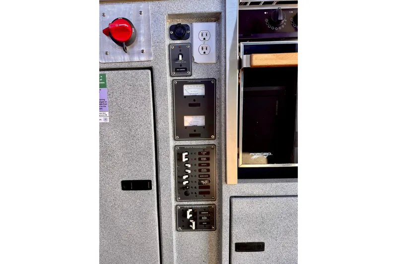 Slide: The Image of Electrical control panel on a 2001 Maxweld Maxcat boat, featuring switches and outlets. - 21