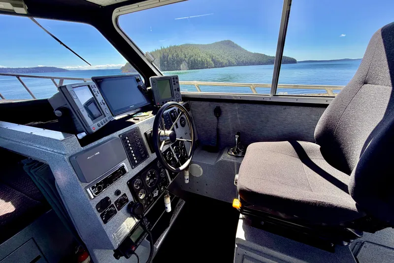 Slide: The Image of Interior of a 2001 Maxweld Maxcat boat cockpit with navigation equipment and scenic water view. - 23