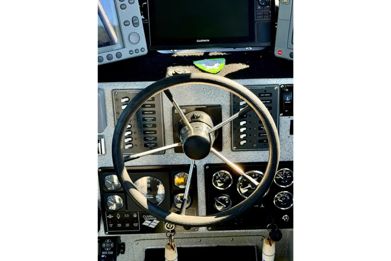 Slide: The Image of Steering wheel and control panel of a 2001 Maxweld Maxcat boat. - 25