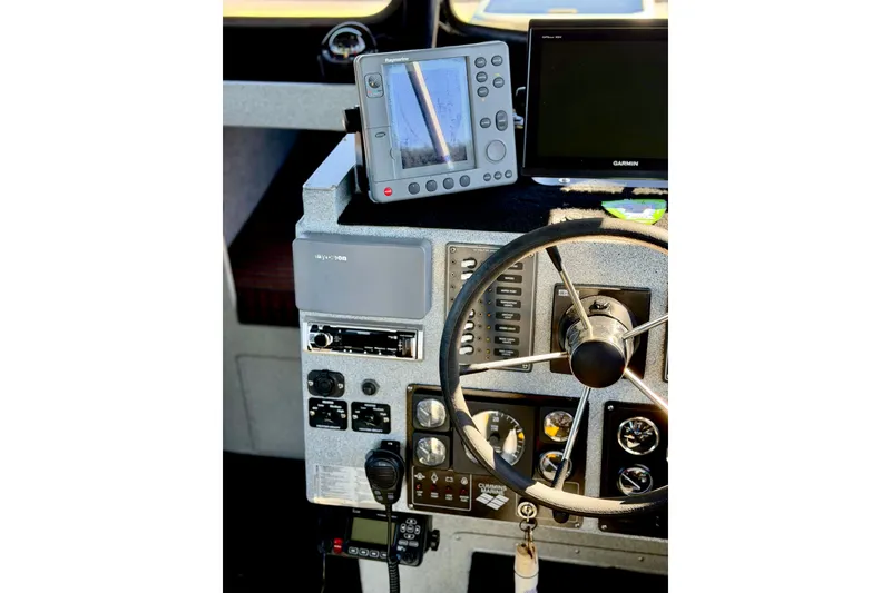 Slide: The Image of Boat dashboard with steering wheel and navigation equipment, Maxweld Maxcat 2001 model. - 26