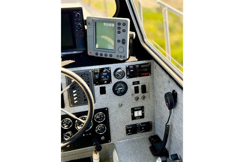 Slide: The Image of Control panel of a 2001 Maxweld Maxcat boat with navigation equipment and gauges. - 27