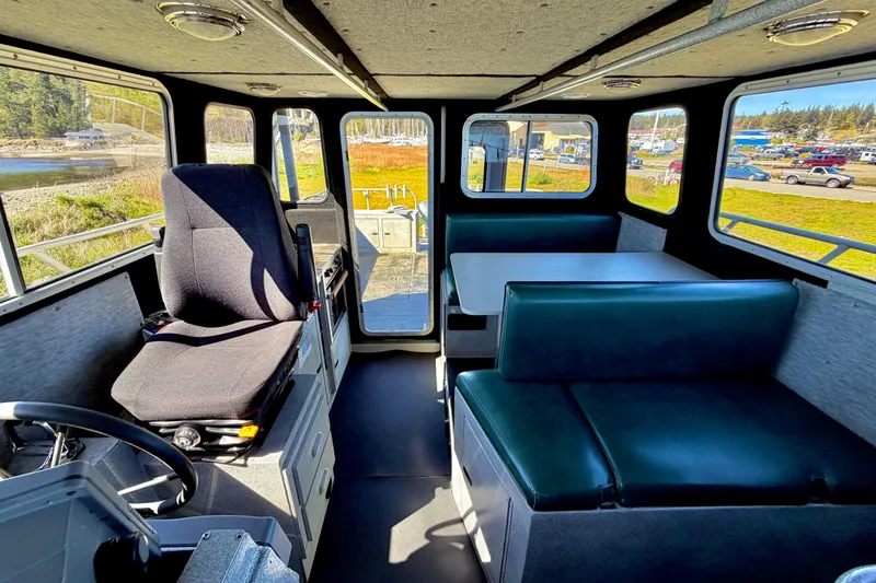 Slide: The Image of Interior of a 2001 Maxweld Maxcat boat with seating and steering area. - 29