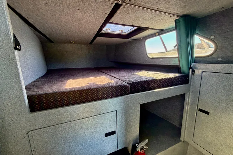 Slide: The Image of Cozy cabin interior of 2001 Maxweld Maxcat boat with bed and storage. - 32
