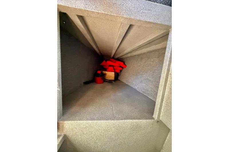 Slide: The Image of Interior storage compartment of a 2001 Maxweld Maxcat boat with safety gear. - 34