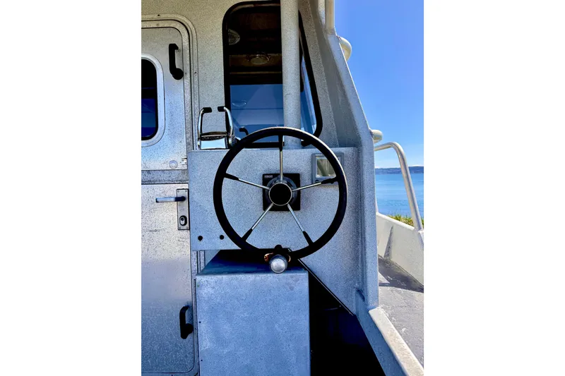 Slide: The Image of Steering wheel of a 2001 Maxweld Maxcat boat with ocean view. - 7