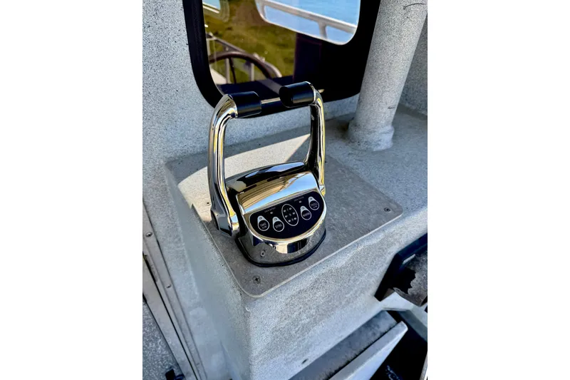 Slide: The Image of Chrome throttle control on a 2001 Maxweld Maxcat boat dashboard. - 8