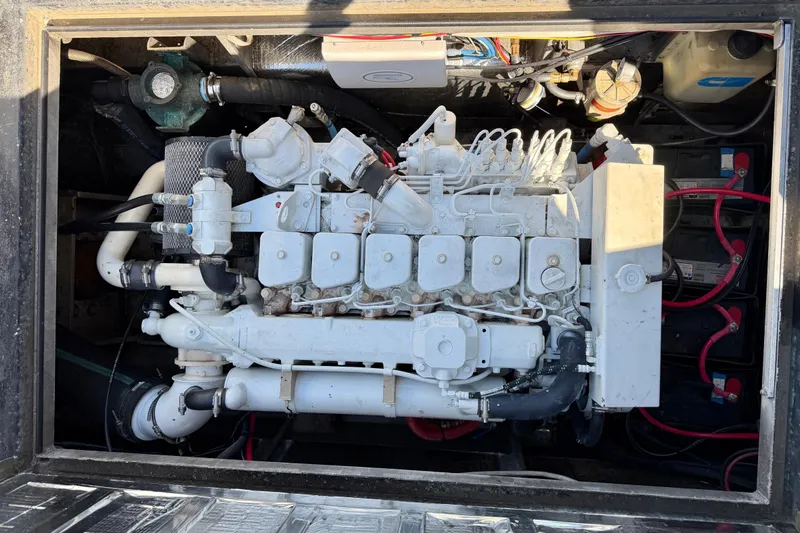 Slide: The Image of Engine compartment of a 2001 Maxweld Maxcat boat, showcasing detailed mechanical components. - 9