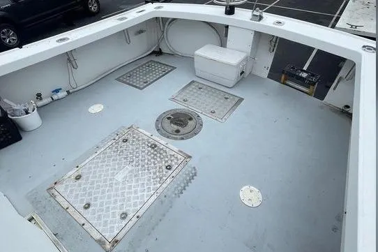 Slide: The Image of 1977 JC 31 Casco Bay boat deck with storage hatches and seating. - 10