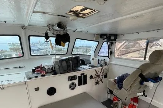 Slide: The Image of Interior of a 1977 JC 31 Casco Bay boat with navigation equipment and captain's chair. - 13