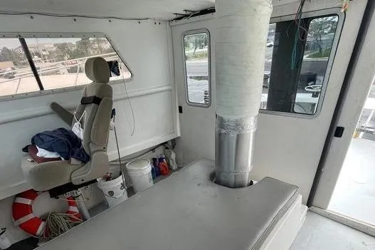 Slide: The Image of Interior of a 1977 JC 31 Casco Bay boat with seating and equipment. - 16