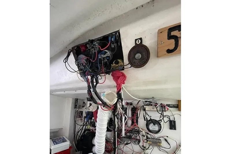 Slide: The Image of Interior wiring of a 1977 JC 31 Casco Bay boat, showing electrical components and cables. - 17