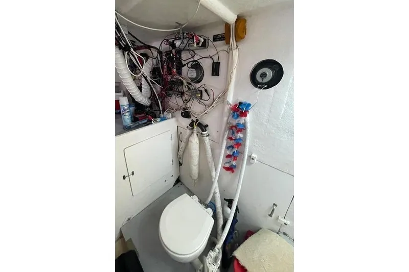Slide: The Image of 1977 JC 31 Casco Bay boat interior with toilet and wiring. - 18