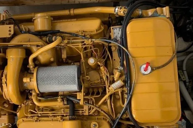 Slide: The Image of Engine of a 1977 JC 31 Casco Bay boat, showcasing intricate mechanical components. - 21