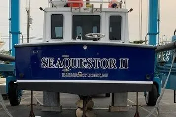 Slide: The Image of 1977 JC 31 Casco Bay boat "SEAQUESTOR II" on dry dock, blue hull, rear view. - 3