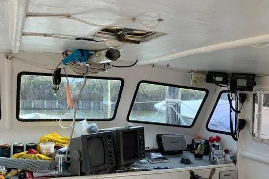 Slide: The Image of Interior of a 1977 JC 31 Casco Bay boat with navigation equipment and windows. - 7