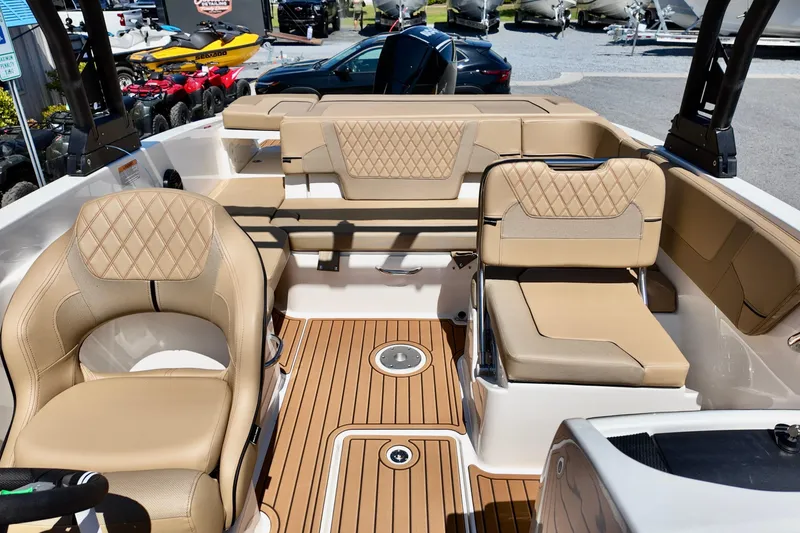Slide: The Image of 2026 Bayliner VR6 Bowrider OB interior with tan seating and teak-style flooring. - 10