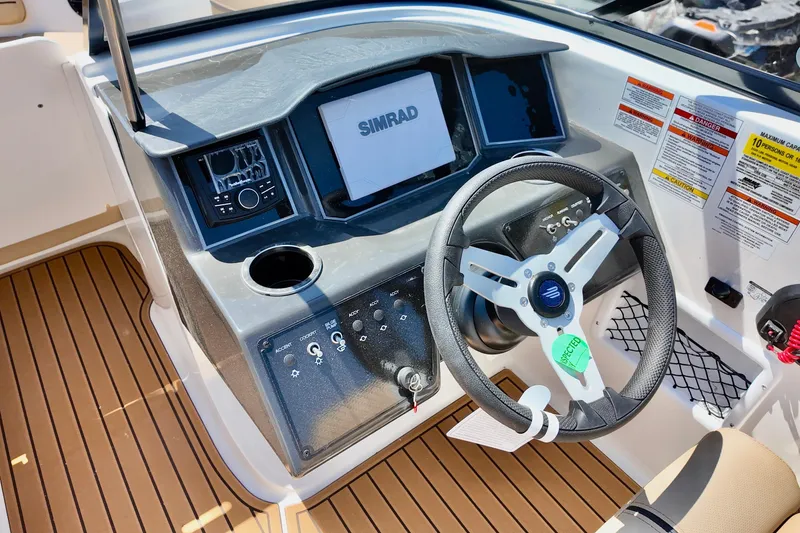 Slide: The Image of 2026 Bayliner VR6 Bowrider OB dashboard with steering wheel and control panel. - 11
