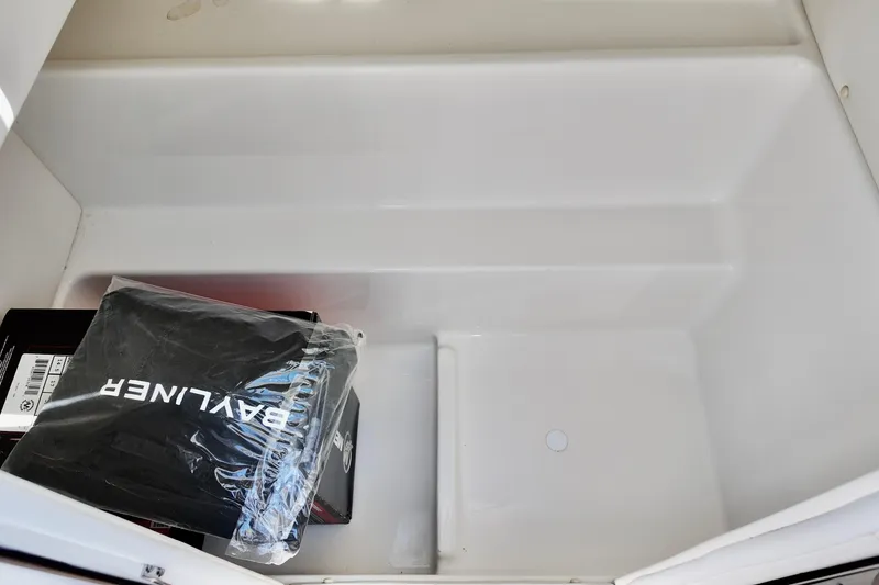 Slide: The Image of Storage compartment of 2026 Bayliner VR6 Bowrider OB with branded packaging. - 12