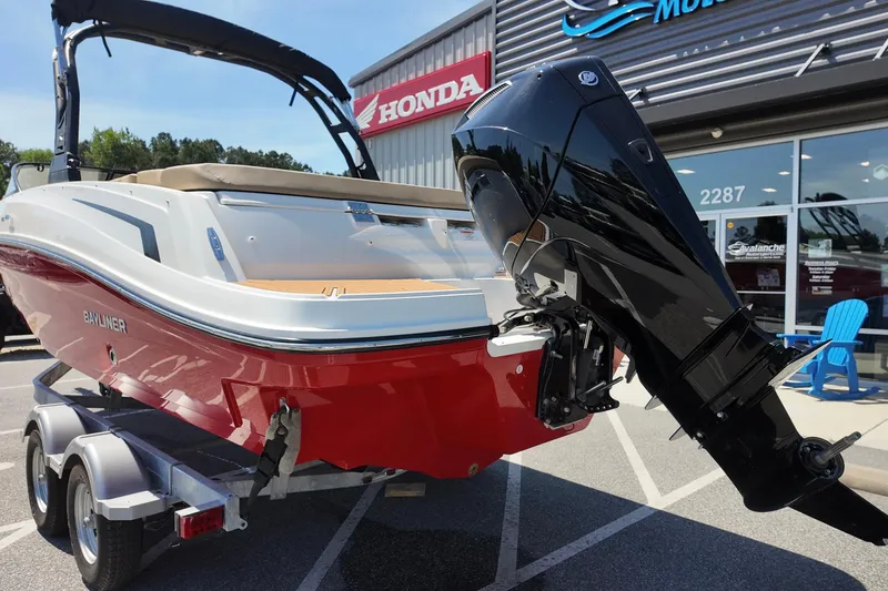 Slide: The Image of 2026 Bayliner VR6 Bowrider OB with outboard motor, parked outside dealership. - 3