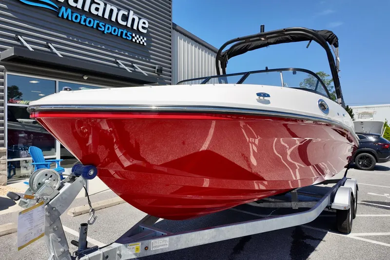Slide: The Image of 2026 Bayliner VR6 Bowrider OB with red hull on trailer at dealership. - 4