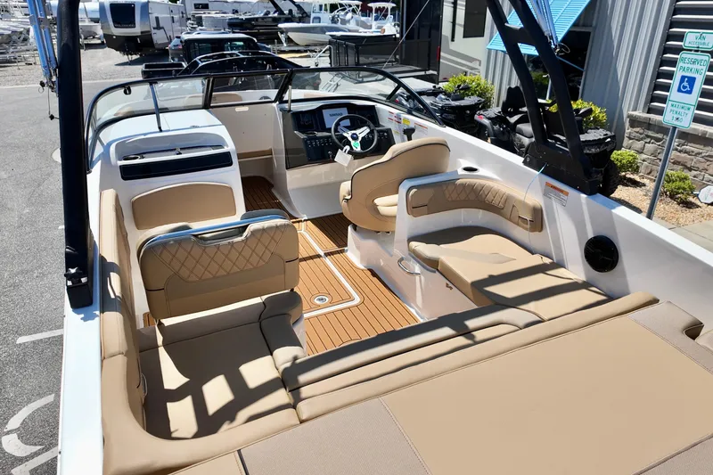 Slide: The Image of 2026 Bayliner VR6 Bowrider OB interior with tan seating and modern dashboard. - 6