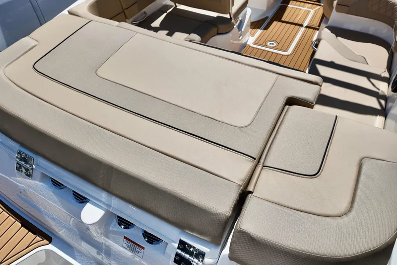 Slide: The Image of 2026 Bayliner VR6 Bowrider OB interior with beige seating and wood accents. - 7
