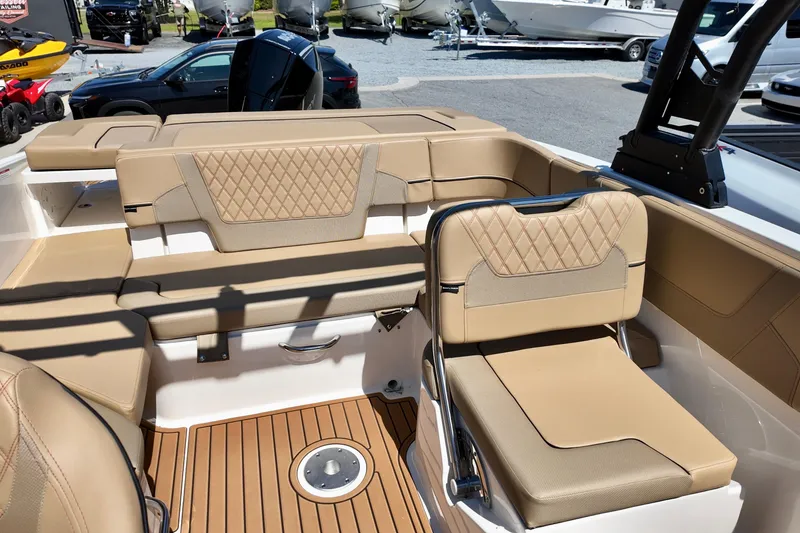 Slide: The Image of 2026 Bayliner VR6 Bowrider OB interior with tan seating and wood-style flooring. - 9