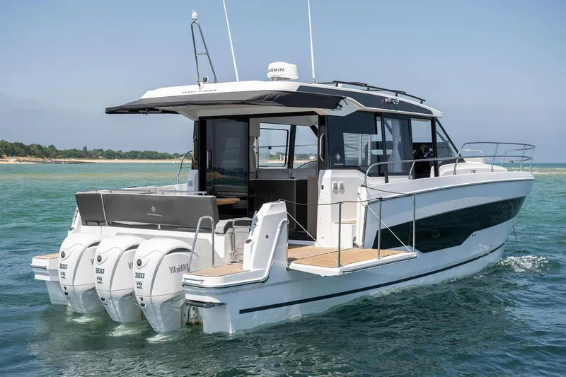 Slide: The Image of Manufacturer Provided Image: 2025 Jeanneau NC 1295 Coupe boat with triple Yamaha engines on open water. - 3