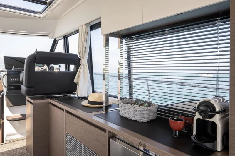 Slide: The Image of Interior of 2026 Jeanneau NC 1295 Coupe yacht with modern kitchen amenities. - 9
