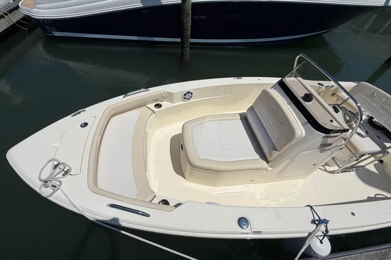 Slide: The Image of 2026 Scout 188 Sportfish boat docked, featuring spacious seating and sleek design. - 3