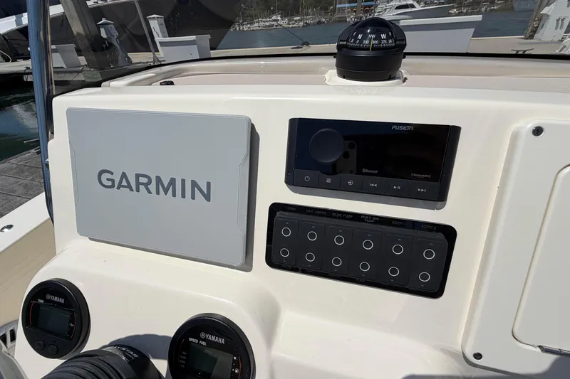 Slide: The Image of 2026 Scout 188 Sportfish dashboard featuring Garmin navigation and Fusion audio system. - 6