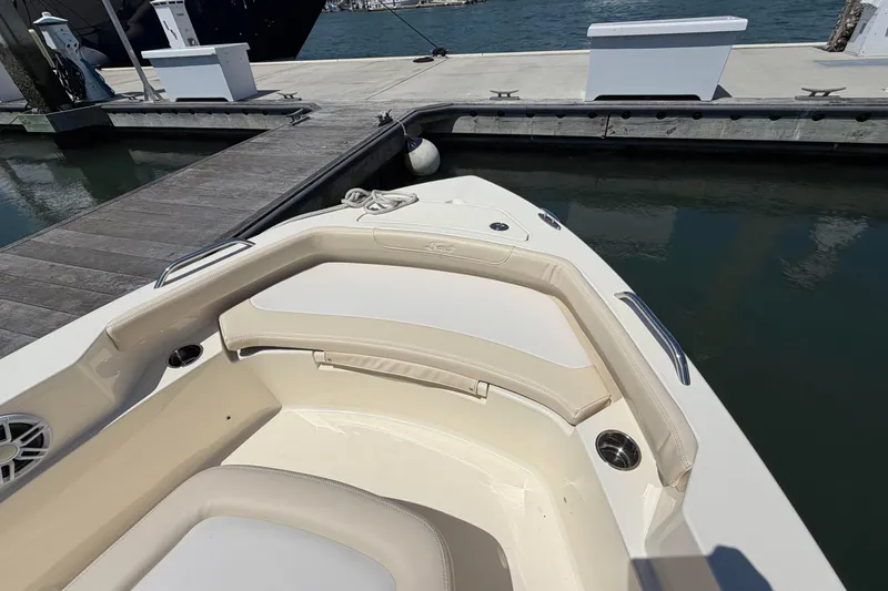 Slide: The Image of Bow seating area of 2026 Scout 188 Sportfish boat docked at marina. - 7