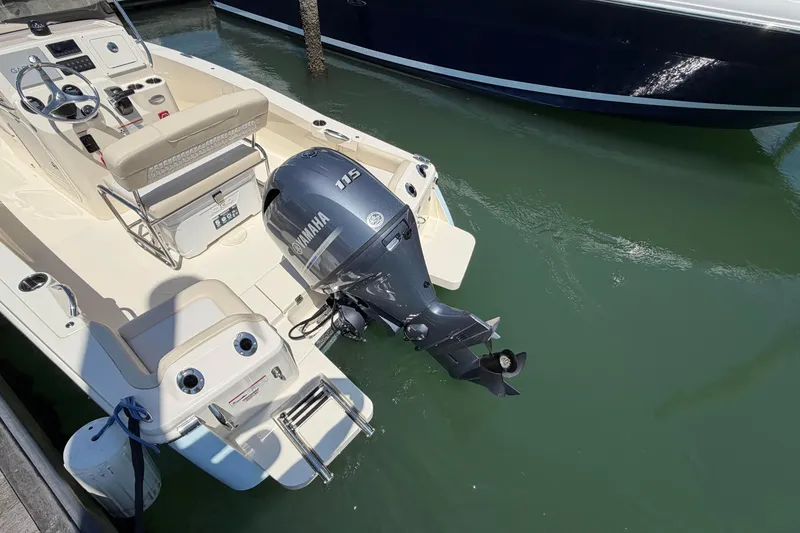 Slide: The Image of 2026 Scout 188 Sportfish boat with Yamaha 115 engine docked in marina. - 9