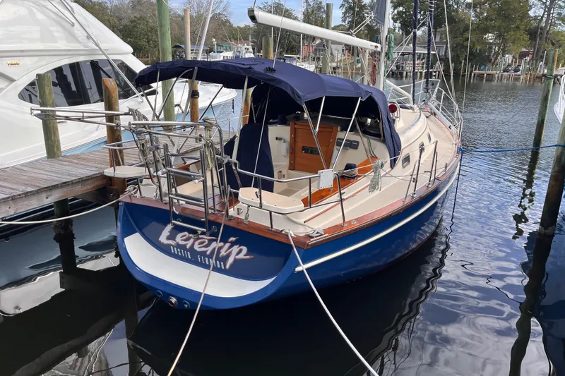 The Image of Island Packet 350 sailboat, 2000 model, docked in a marina with blue canopy. - 0