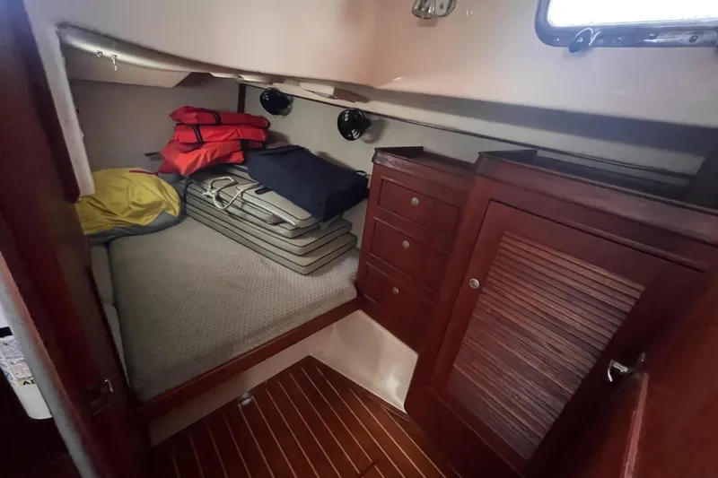 Slide: The Image of Interior cabin of 2000 Island Packet 350 sailboat with storage and life jackets. - 15