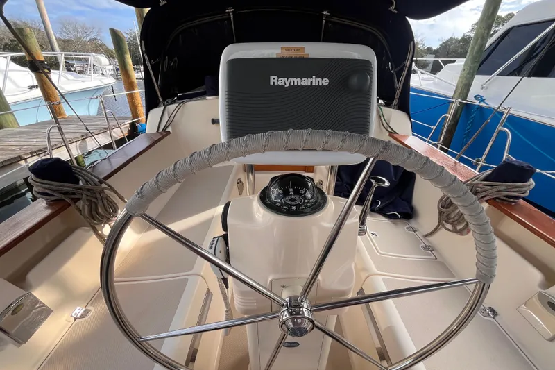 Slide: The Image of Steering wheel and navigation equipment on a 2000 Island Packet 350 sailboat. - 17