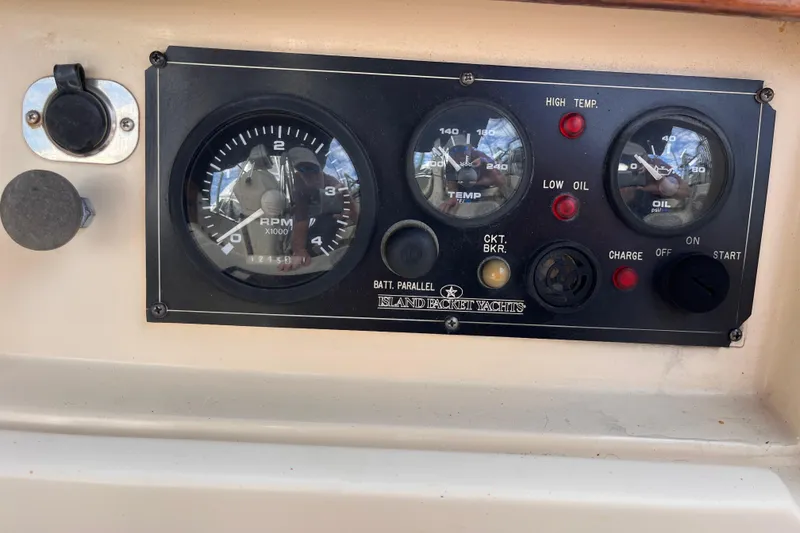 Slide: The Image of Control panel of a 2000 Island Packet 350 yacht with RPM, temperature, and oil gauges. - 20