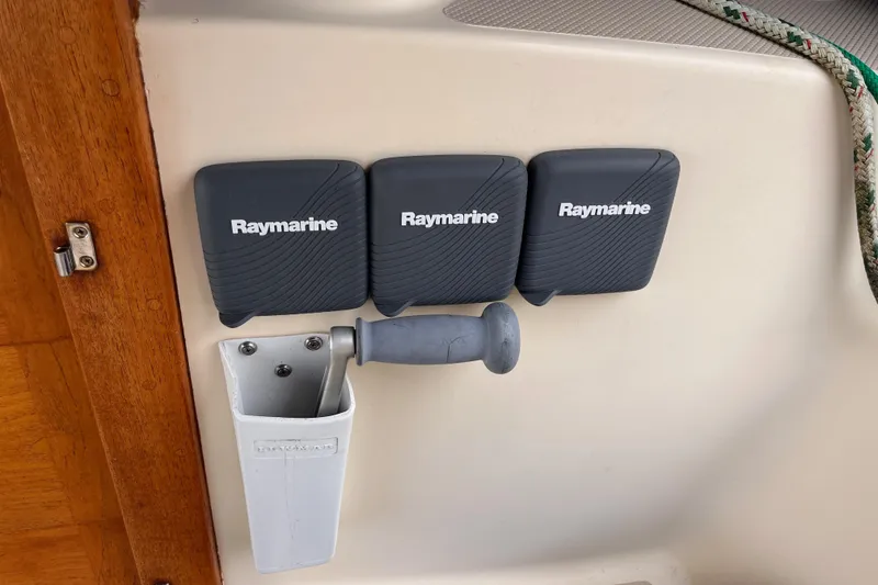Slide: The Image of Raymarine equipment on 2000 Island Packet 350 sailboat, featuring protective covers and a handle. - 24